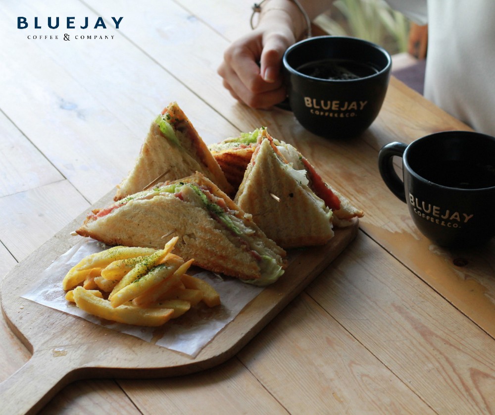 Give yourself a delicious treat with Bluejay Coffee’s Country Clubhouse Panini with Fries and high-quality coffee.